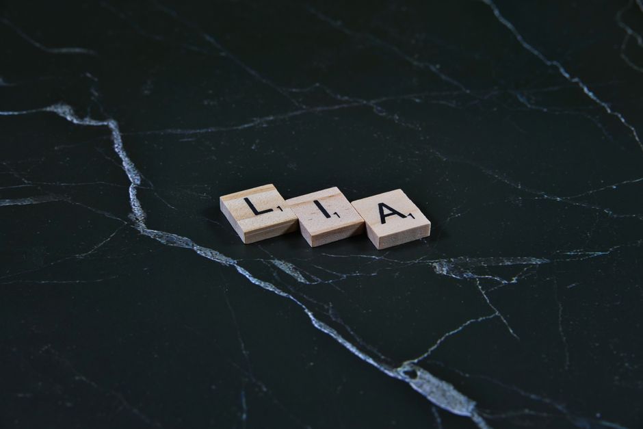 Wooden letter tiles spelling on dark marble, offering a classic and minimalist aesthetic.